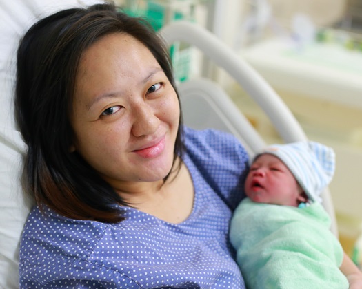 Mother holding her newborn child after labor