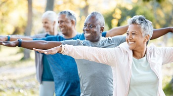 Stretching, yoga and senior people in park for muscle health, workout and training with retirement community. Pilates, exercise and happy elderly friends, group or women and men for fitness in nature